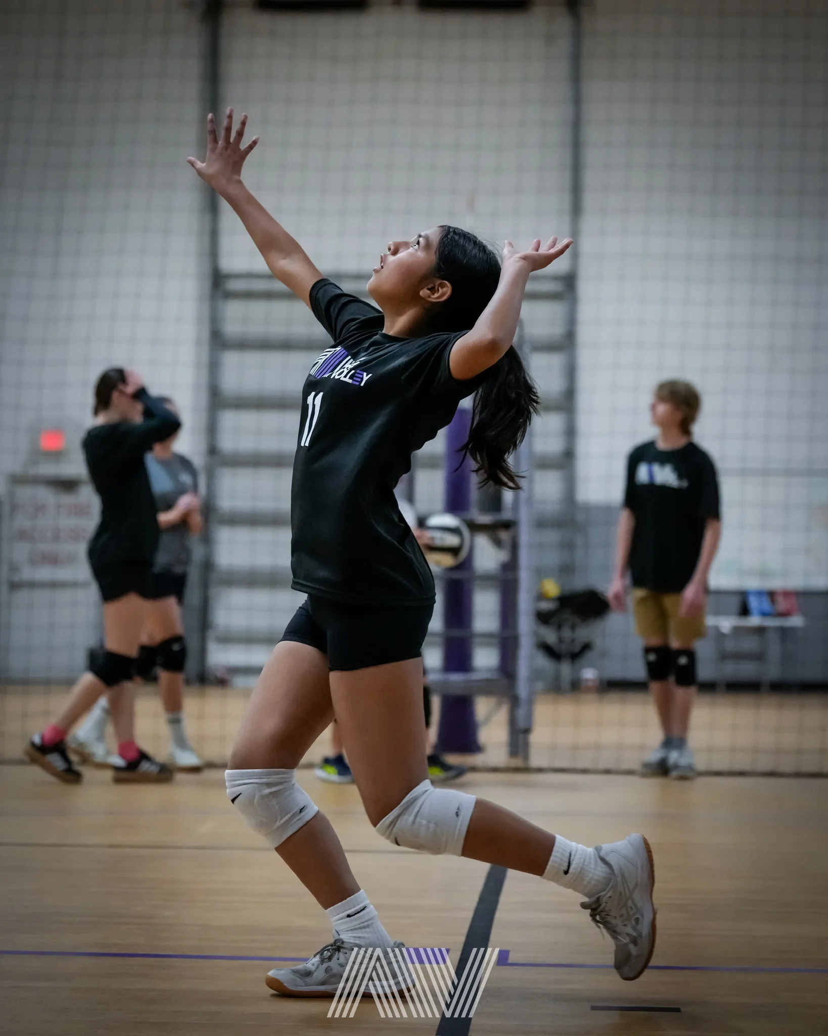 A4 Volleyball athlete serving during practice